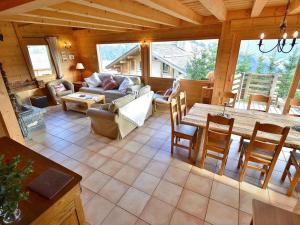 a living room with a couch and a table at Chalet Le Grand-Bornand, 7 pièces, 10 personnes - FR-1-391-19 in Le Grand-Bornand