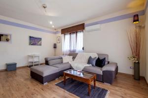 sala de estar con sofá y mesa de centro en REVO Apartments - Casa Viola, en Berbenno di Valtellina