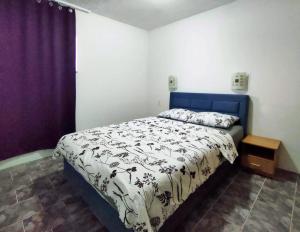 a bedroom with a bed with a blue and white comforter at Skajla Apartments in Medulin