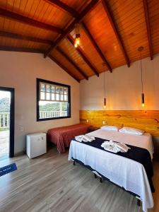 a bedroom with a bed in a room with wooden ceilings at Estância do Biribiri in Diamantina