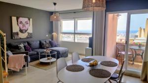 a living room with a couch and a table at Carmen Apartamento Millón - Private roof terrace with Jacuzzi & BBQ in Nerja