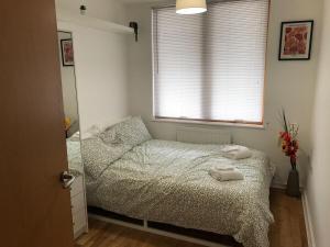 a bedroom with a bed with two towels on it at May Disc - Long Stay - Contractors in Bristol