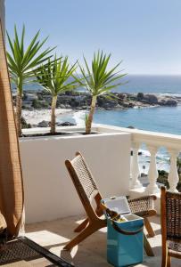 a chair on a balcony with a view of the ocean at Scenic Serenity in Clifton - Number 6306 in Cape Town