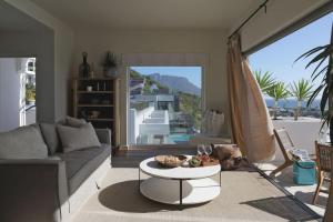 a living room with a couch and a table at Scenic Serenity in Clifton - Number 6306 in Cape Town