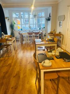 uma sala de jantar com mesas e cadeiras de madeira em Idan House em Llanberis