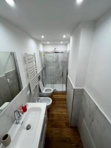 a white bathroom with a sink and a toilet at Lazio apartment nel centro di Palermo in Palermo
