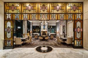 a lobby of a hotel with a table and chairs at Loews New Orleans Hotel in New Orleans