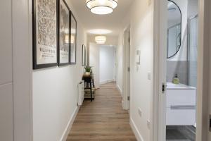 a hallway with white walls and wood floors at Stunning two bedroom in city centre in Southampton