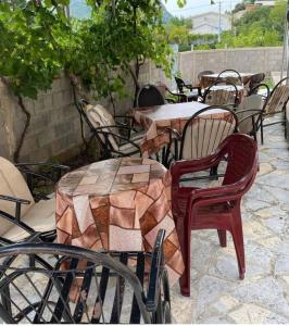 a group of tables and chairs in a patio at Milica Apartments in Sutomore