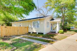 a small white house with a wooden fence at Lovely Mobile Home with Smart TV 2 Mi to Downtown! in Mobile