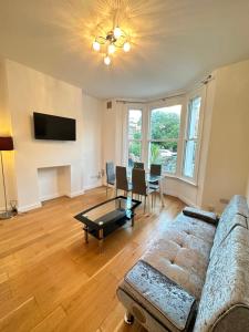 a living room with a couch and a table at 2 Bedroom & Living Room Apartment In Paddington in London