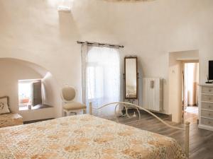 a bedroom with a bed and a dresser and a mirror at Masseria trulli pietra antica in Noci