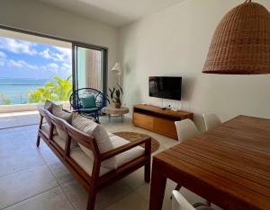 a living room with a view of the ocean at Ocean grand gaube in Grand Gaube