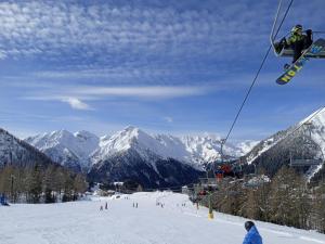 a person is riding a ski lift in the snow at A casa di Ale - Foppolo in Foppolo