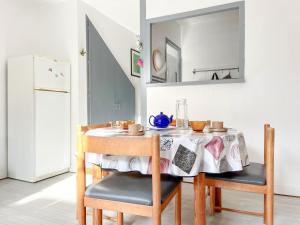 a dining room table with a table cloth on it at Agréable appartement proche de Port Olonna - 4 pers in Les Sables-dʼOlonne