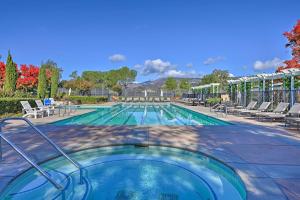 a large swimming pool with chairs at Resort-Style Napa Studio Close to Wineries! in Napa