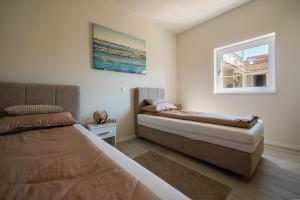 a bedroom with two beds and a window at Villa Mirage with Private Heated Pool in Orebić +25 photos