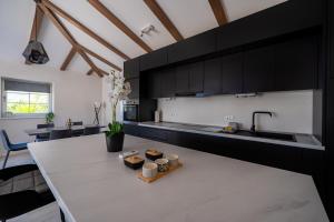 a kitchen with black cabinets and a table with candles at Villa Mirage with Private Heated Pool in Orebić