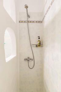 a shower in a white bathroom with a shower at Sea and Sun beach house at Platis Gialos in Platis Gialos