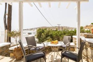 a patio with chairs and a table on a balcony at Sea and Sun beach house at Platis Gialos in Platis Gialos