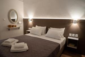 a bedroom with a large bed with two towels on it at V&V Acropolis view apartment in Athens