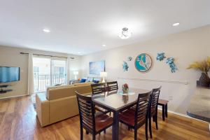 a living room with a couch and a table and chairs at The Palm Bay Club Unit 311 in Siesta Key