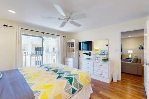 a bedroom with a bed and a ceiling fan at The Palm Bay Club Unit 311 in Siesta Key +37 photos