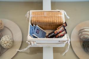 a basket with books and magazines on a table at V&V Acropolis view apartment in Athens