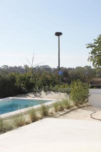 een zwembad in het midden van een park bij Casa Menina do Mar in Carvalhal Beach in Grândola
