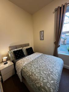 a bedroom with a bed and a window at Central City Castle Apartment FREE parking Private in Nottingham