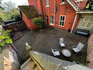 an aerial view of a patio with chairs and a table at The Castle Apartment, Lots of Character Cosy and Comfortable, Private Garden and FREE Parking in Nottingham