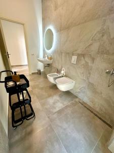 a bathroom with two white sinks and a mirror at Queen’s Luxury Vila 111/A in Dhërmi +24 photos