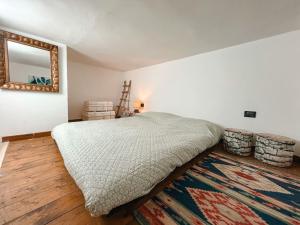 a bedroom with a bed and a mirror and a rug at CasaBlu in Cormano
