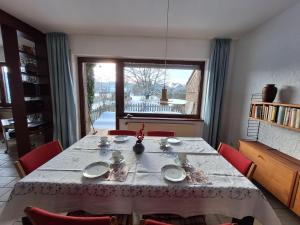 a dining room with a table and chairs and a window at Ferienwohnungen Burgstraße 8 in Blankenheim