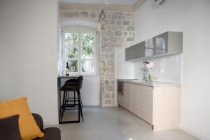 a kitchen with a sink and a counter with a window at Palazzo Sindik in Kotor