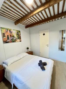 a bedroom with a white bed with a towel on it at Ramban Emerald in Haifa