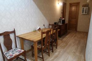 a dining room with a wooden table and chairs at guest house Merci in Tbilisi City