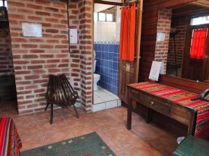 a room with a bathroom with a piano and a toilet at Bellavista Cloud Forest Lodge & Private Protected Area in Tandayapa