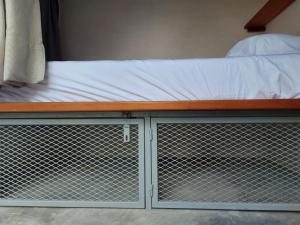 a bunk bed with a metal fence around it at Elmar hostal in Bacalar