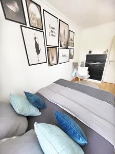 a bedroom with a large bed with blue pillows at Moderne Ferienwohnung in Friedrichshafen