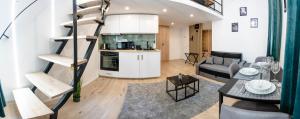 a kitchen and a living room with a spiral staircase at Kalvin Apartments in Budapest