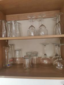 a bunch of glass jars and bottles on a shelf at Alberta Holiday Park, HC13 in Seasalter