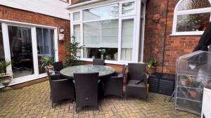a patio with a table and chairs and a building at Welholme Avenue Luxury Place in Great Coates