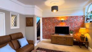 a living room with a couch and a flat screen tv at Welholme Avenue Luxury Place in Great Coates