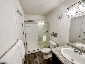 a bathroom with a toilet and a sink and a shower at Sleepover Nashville Studio Apartments in Nashville