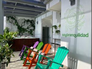 a row of colorful chairs in front of a store at Hotel Sixtina Plaza Medellin in Medellín