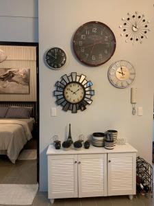 a group of clocks on the wall in a bedroom at The Nest in Oceanway Boracay in Boracay