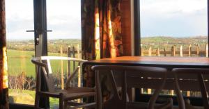 a table and two chairs in front of a window at Panorama Peace Nature in Castlewellan