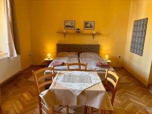 a bedroom with a bed with a table and chairs at Penzion U Báby in Třeboň