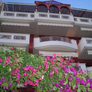 a building with pink flowers in front of it at Lido Studios in Loutra Edipsou